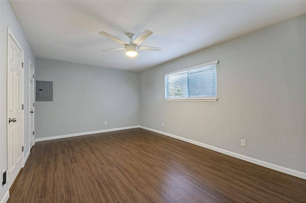 10207 Regal Oaks Drive, #210, Dallas, TX 75230 Wood-finish flooring, white trim, recessed window, and overhead ceiling fan with integrated lighting