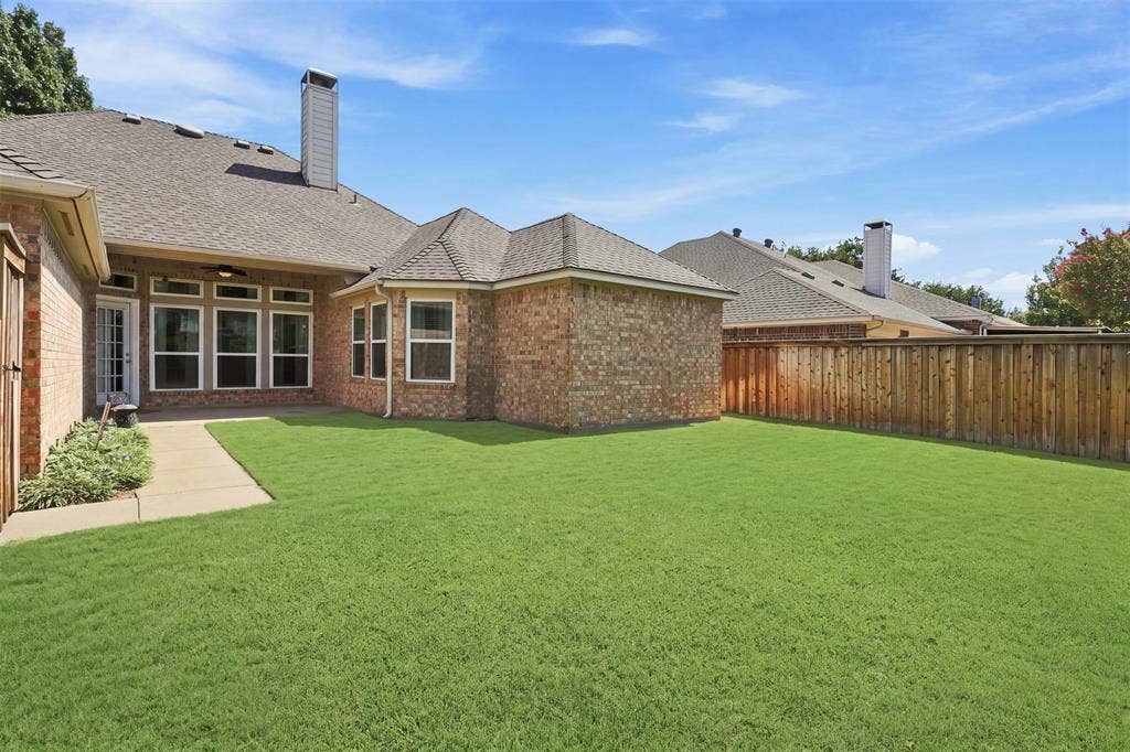3617 Mackenzie Lane, Richardson, TX 75082 Large backyard with St Augustine grass and landscaping.