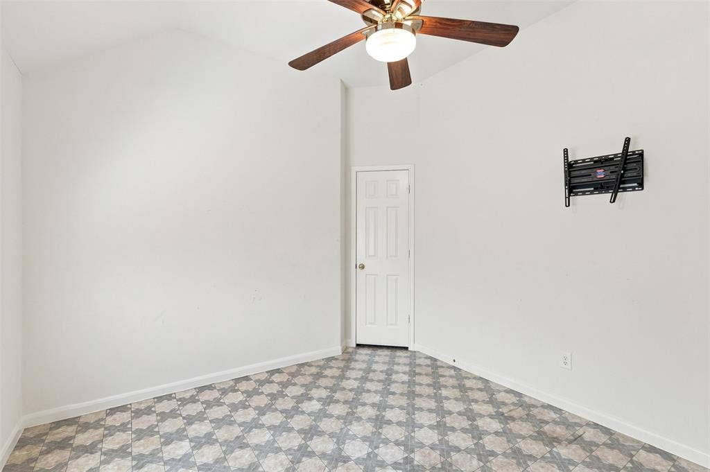 3617 Mackenzie Lane, Richardson, TX 75082 Fourth bedroom with patterned vinyl flooring and TV mount with large walk-in closet.