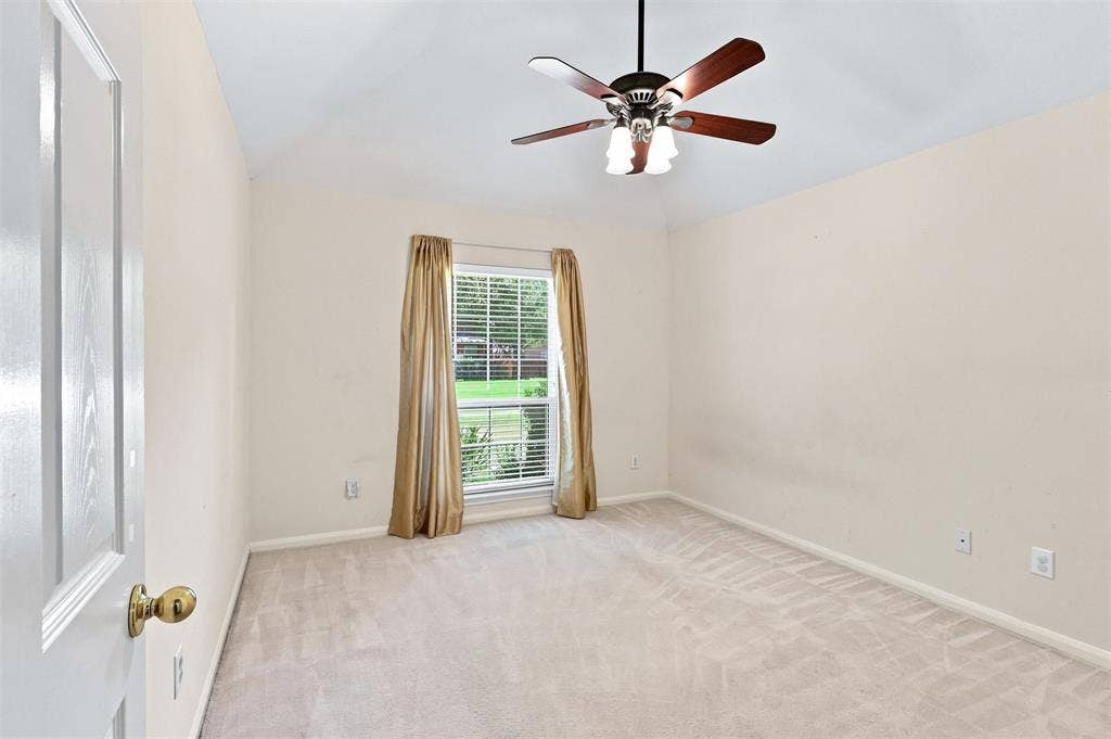 3617 Mackenzie Lane, Richardson, TX 75082 Third bedroom with vaulted ceiling, window looking to front of home and neutral carpet.