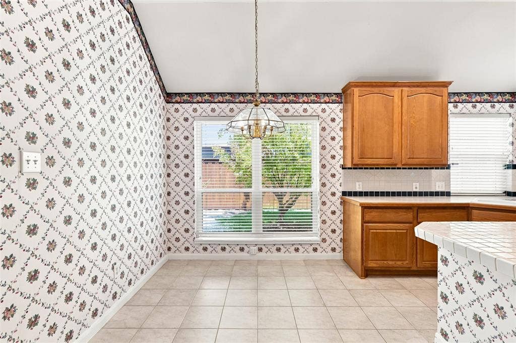 3617 Mackenzie Lane, Richardson, TX 75082 Dining area with a large window and light fixture to define the space.