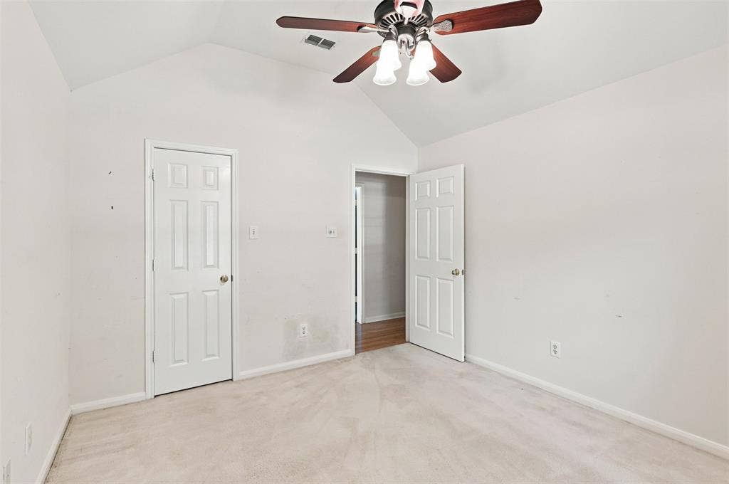 3617 Mackenzie Lane, Richardson, TX 75082 Vaulted ceiling, ceiling fan with integrated lighting, paneled interior doors, and carpet flooring