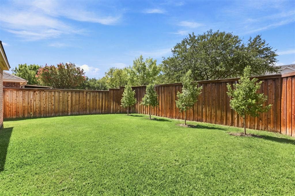 3617 Mackenzie Lane, Richardson, TX 75082 Additional backyard features include full-height privacy fencing, and view of mature trees.