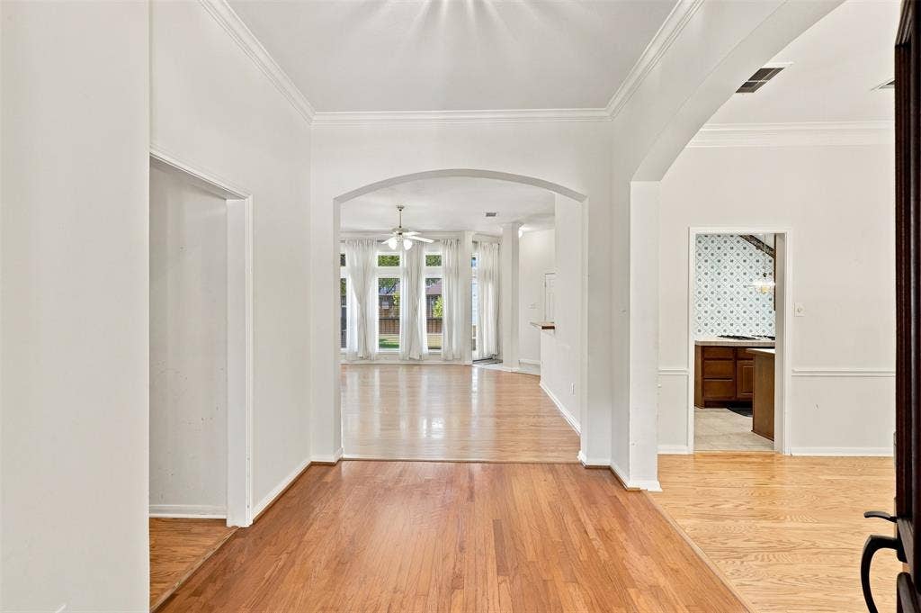3617 Mackenzie Lane, Richardson, TX 75082 Hardwood floors throughout the entry with arched openings to living room and dining room.