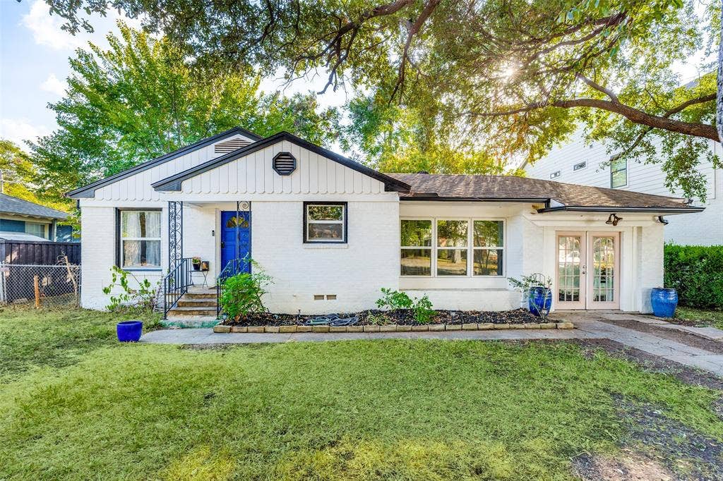 559 Blanning Drive, Dallas, TX 75218 White brick exterior with a distinctive blue entry door