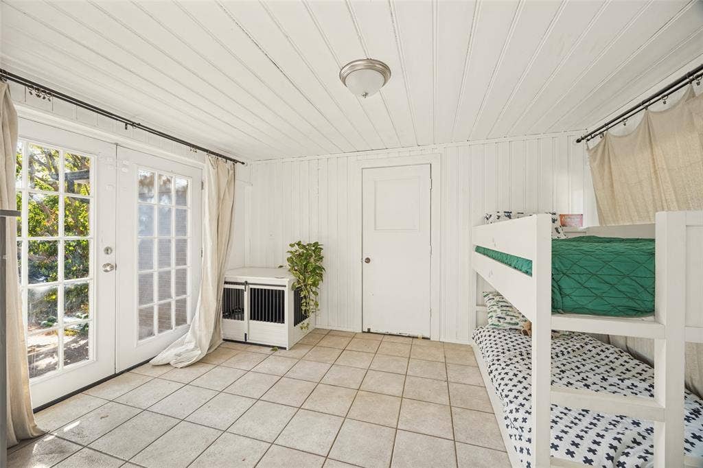 559 Blanning Drive, Dallas, TX 75218 White paneled walls and ceiling, tile flooring, French doors with glass panes, and a flush-mount ceiling light fixture