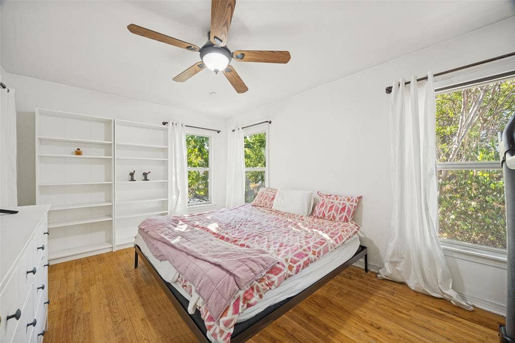 559 Blanning Drive, Dallas, TX 75218 Hardwood flooring , a ceiling fan with integrated lighting, two windows, and built-in shelving