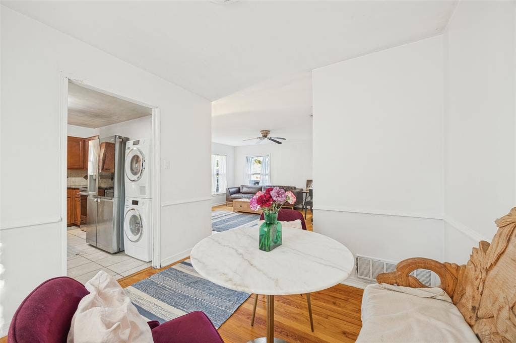 559 Blanning Drive, Dallas, TX 75218 Hardwood flooring, white wall paint, wall trim, recessed ceiling, and kitchen with stainless steel appliances
