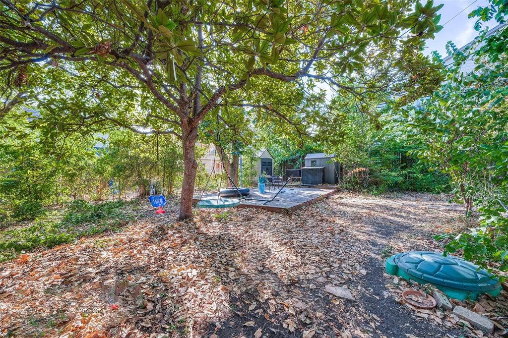 559 Blanning Drive, Dallas, TX 75218 Expansive yard space featuring mature trees and a wood deck