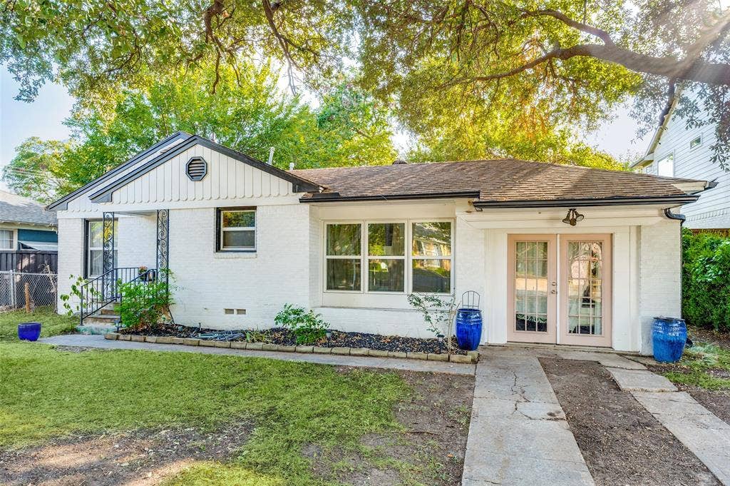 559 Blanning Drive, Dallas, TX 75218 White brick exterior with a dark shingle roof