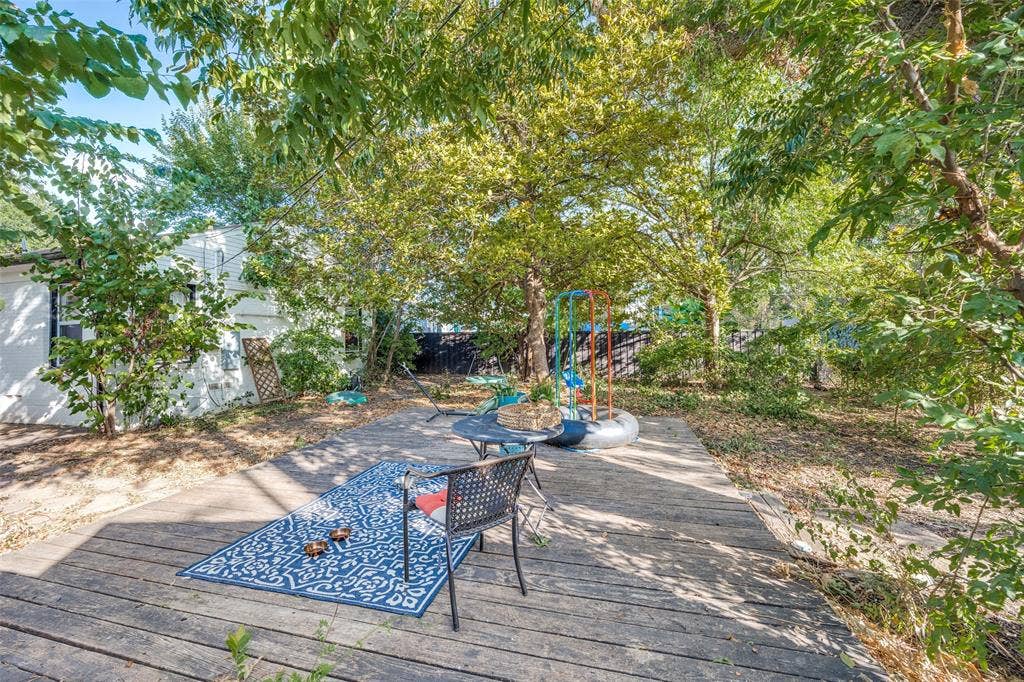 559 Blanning Drive, Dallas, TX 75218 Wood-finish patio with a stone path and established trees