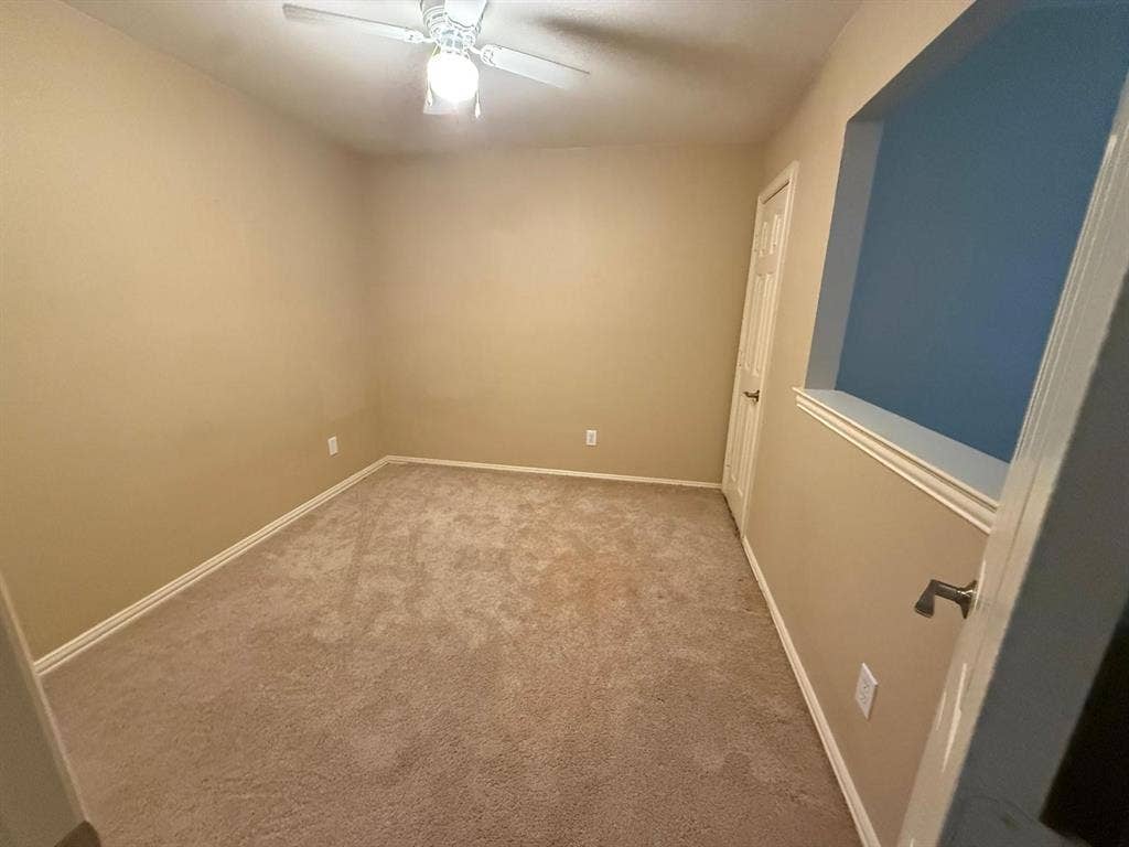 10012 Castlewood Drive, Plano, TX 75025 Neutral-toned walls complement plush carpeting