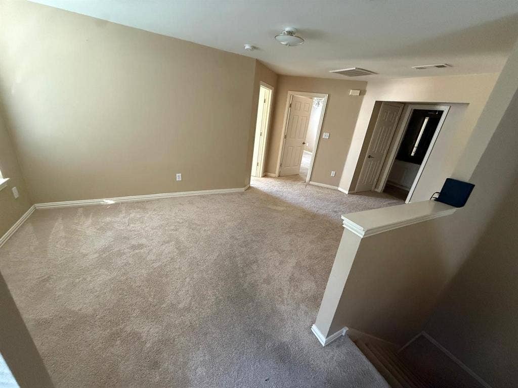 10012 Castlewood Drive, Plano, TX 75025 Neutral carpeting, light neutral wall paint, white trim, and a ceiling light fixture