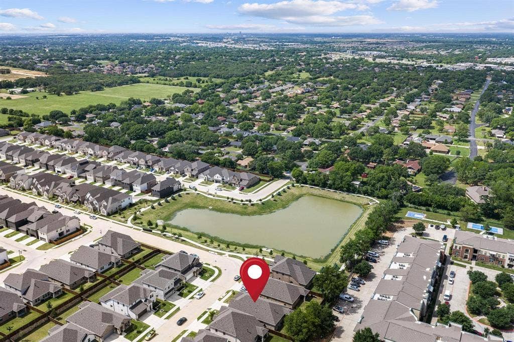 Residential community with a large retention pond and surrounding green space