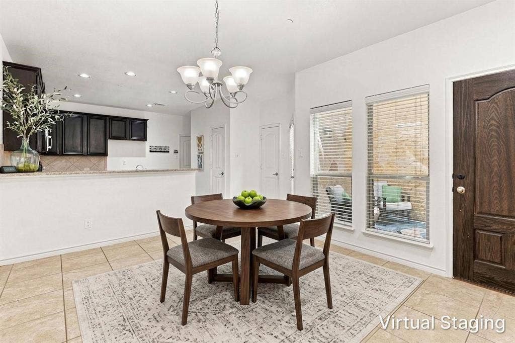 5605 Cojimar Drive, McKinney, TX 75070 Open concept dining area with tile flooring, a chandelier, and two windows - Virtually Staged
