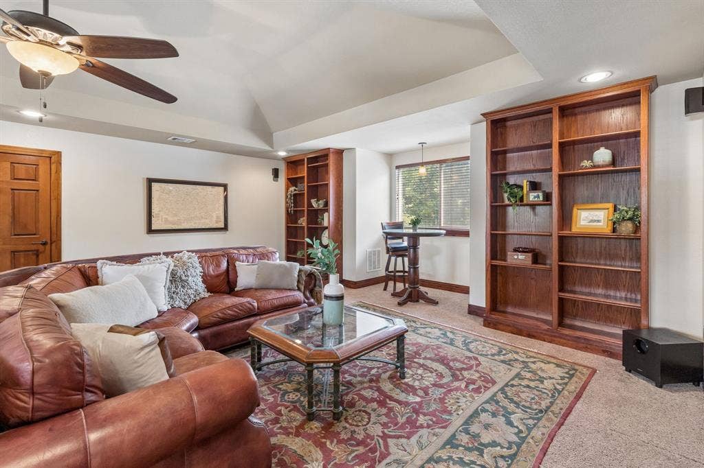 3227 Berry Hollow, Melissa, TX 75454 Vaulted ceiling with a ceiling fan, recessed lighting, and built-in wood bookshelves