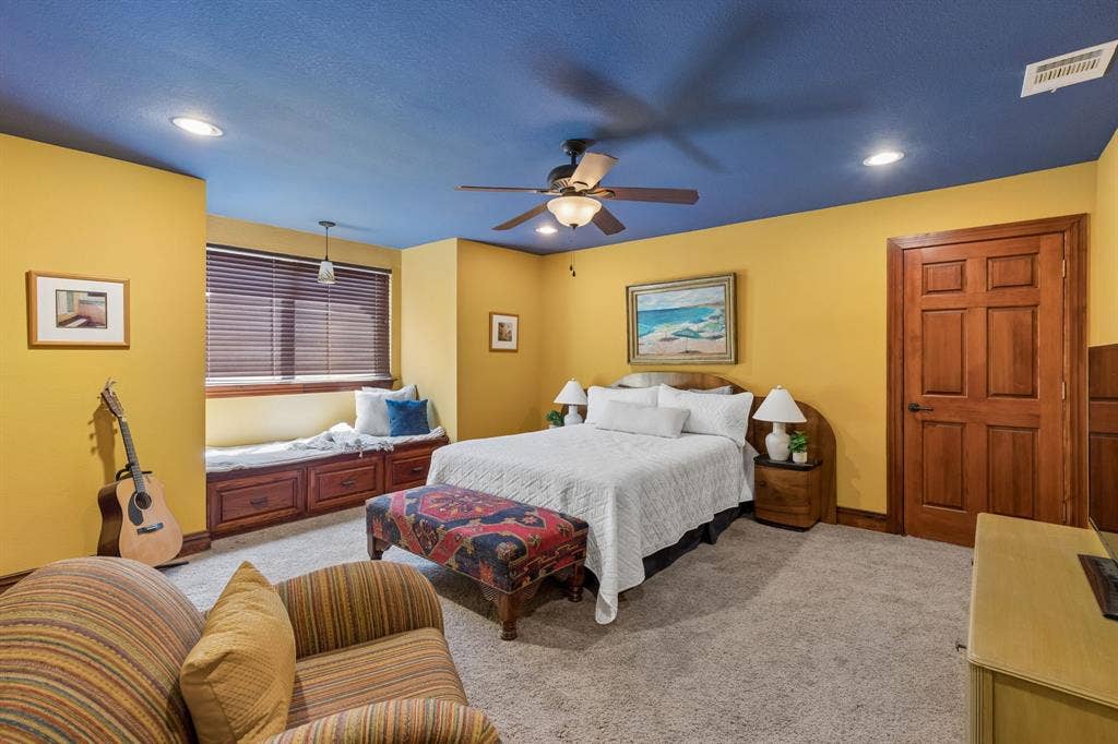 3227 Berry Hollow, Melissa, TX 75454 Guest bedroom #3 located upstairs just off the large game room. Recessed lighting, ceiling fan with light fixture, built-in window bench with storage, wood-finish window blinds, and paneled wood-finish door