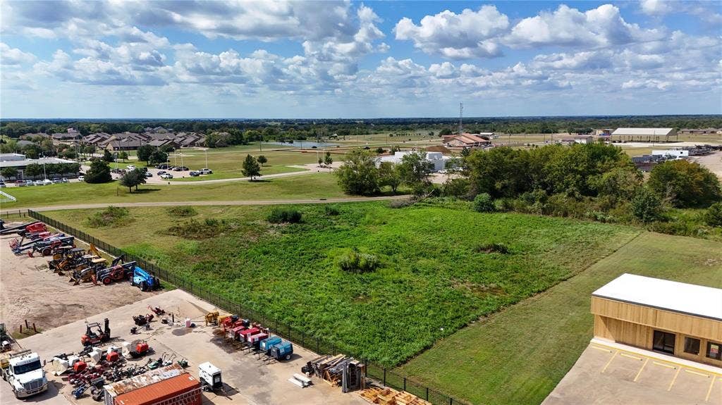 101 Lea Dr, Gun Barrel City, TX 75156 Expansive undeveloped parcel with established perimeter fencing, substantial green space, and surrounding commercial and residential areas