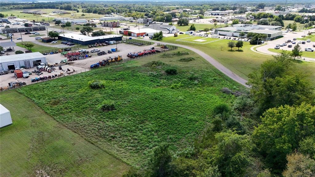 101 Lea Dr, Gun Barrel City, TX 75156 Expansive undeveloped land featuring natural vegetation and surrounding commercial structures