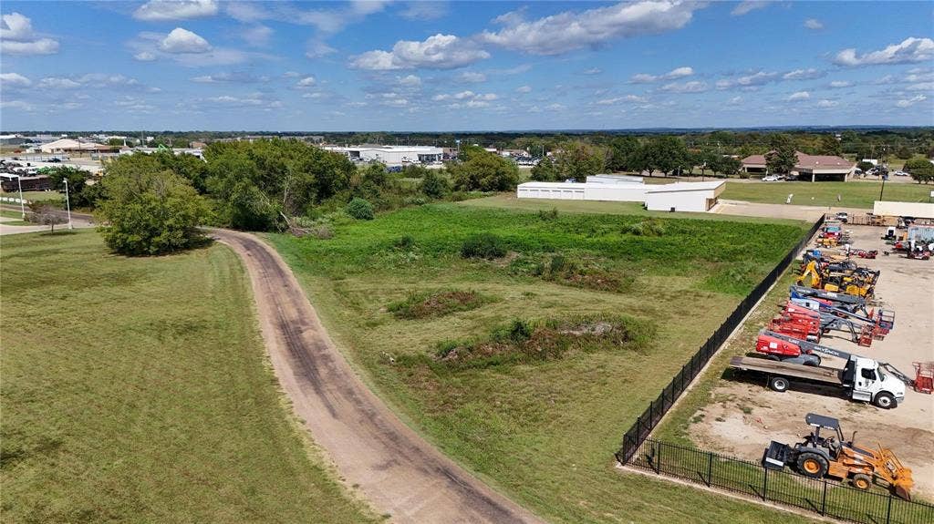 101 Lea Dr, Gun Barrel City, TX 75156 Expansive open land featuring a dirt access road, grassy areas, and mature trees