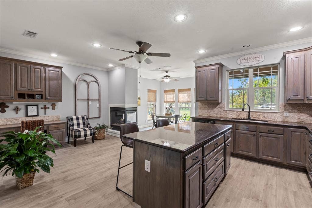 Kitchen off of living room with island, breakfast area and sitting area.