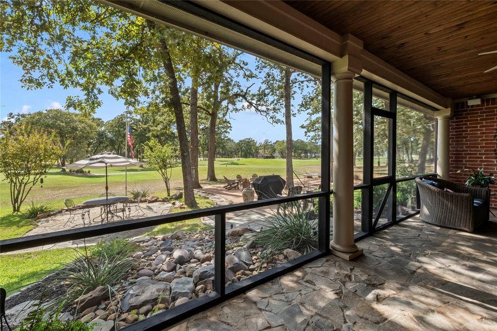 Screened in porch overlooking backyard and golf course