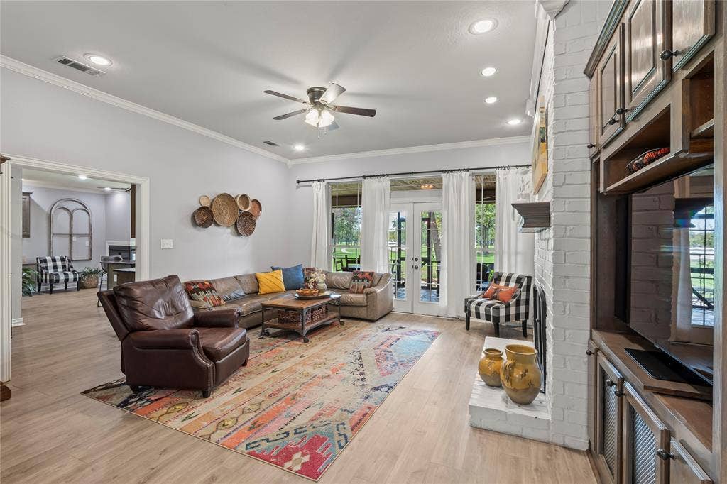 living room with french doors looking out to backyard and golf course