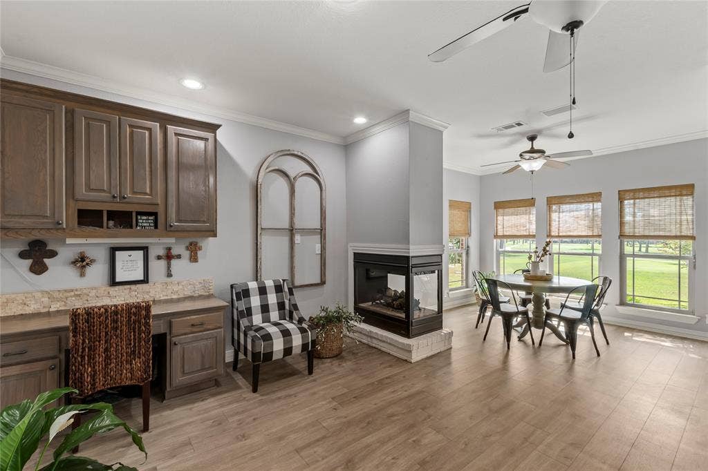 2nd living area in kitchen with gas fireplace and built in desk.