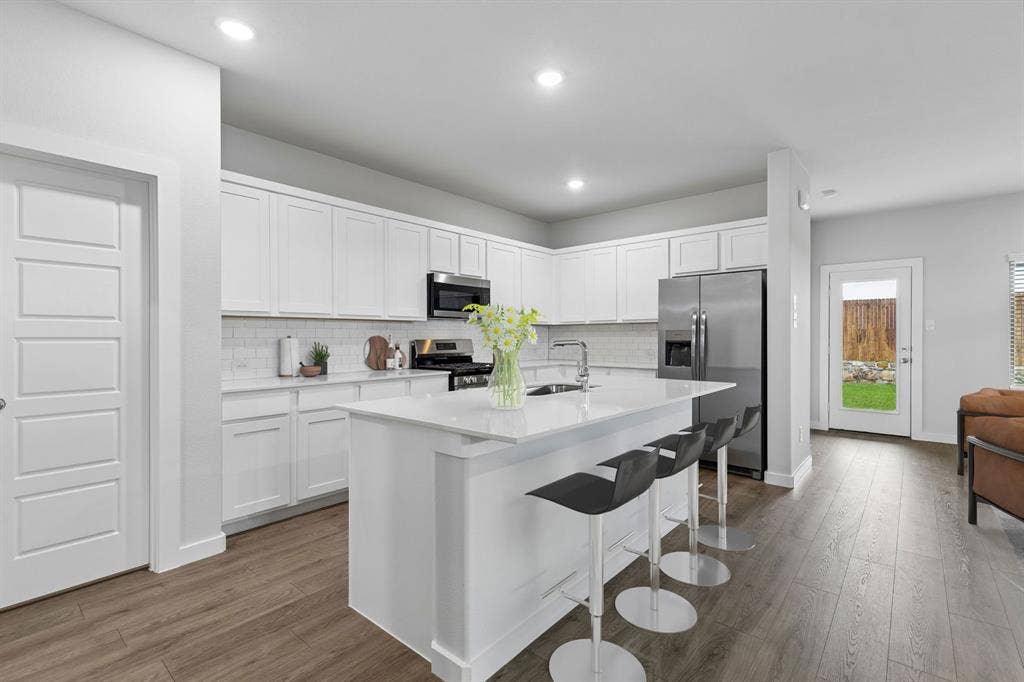 1116 Del Rio Drive, Lavon, TX 75166 Kitchen in the Oscar home plan by Trophy Signature Homes – REPRESENTATIVE PHOTO