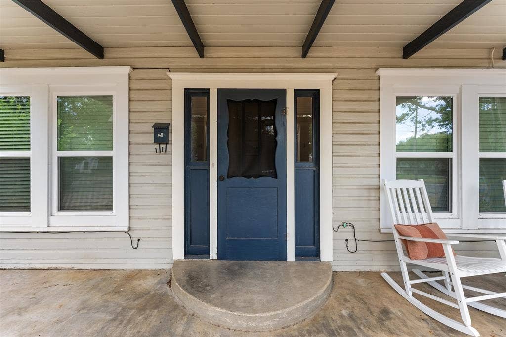 302 W Broadway Street, West, TX 76691 Covered porch with concrete surface, horizontal siding, and exposed ceiling beams