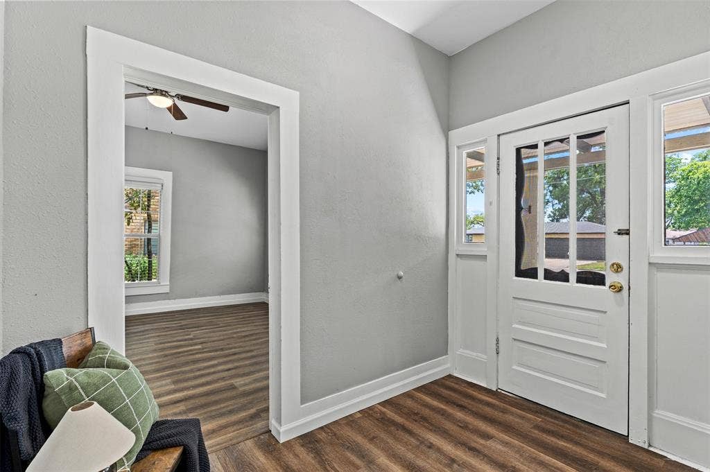 302 W Broadway Street, West, TX 76691 Wood-finish flooring throughout, bright white trim, and a paneled entry door with glass inserts