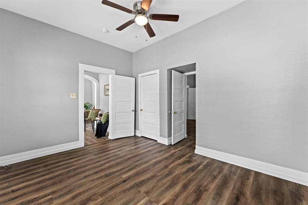 302 W Broadway Street, West, TX 76691 Wood-finish flooring with crisp white trim, light gray painted walls, and a ceiling fan with integrated lighting