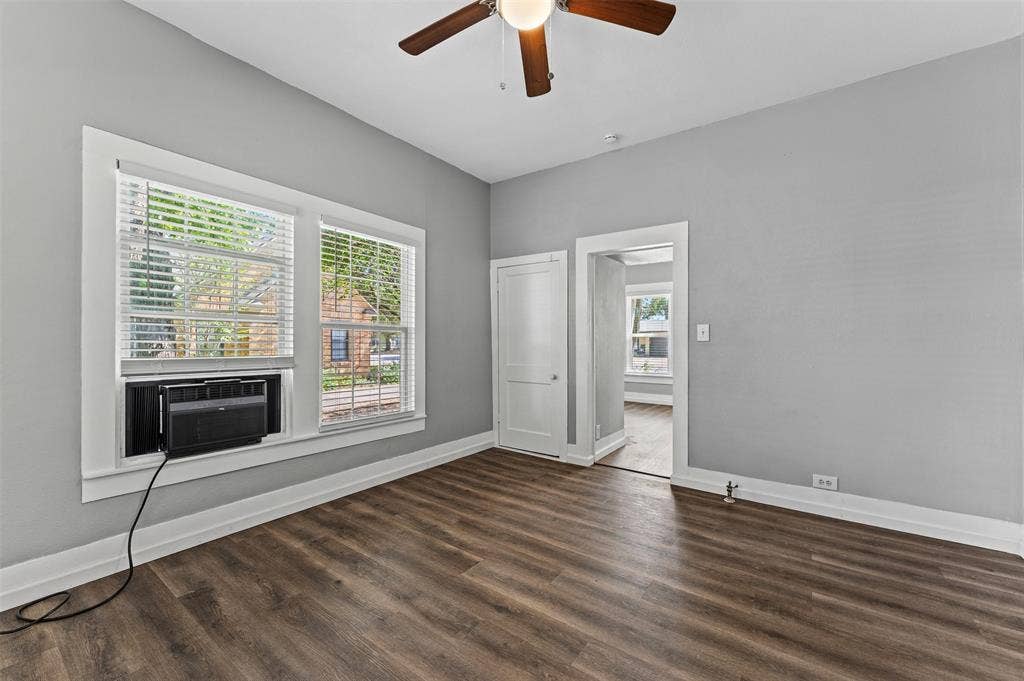302 W Broadway Street, West, TX 76691 Wood-finish flooring, ceiling fan with integrated lighting, and multiple windows with blinds