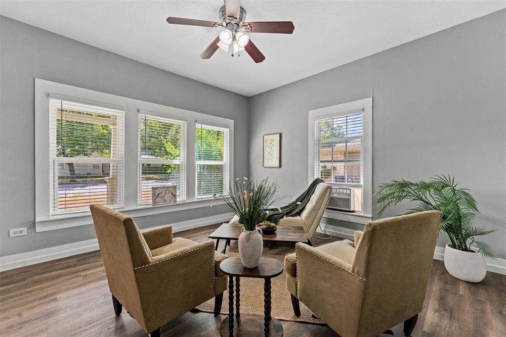 302 W Broadway Street, West, TX 76691 Wood-finish flooring with light gray walls, white trim, and a ceiling fan