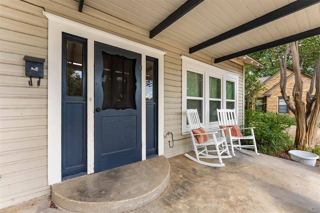 302 W Broadway Street, West, TX 76691 Covered front porch with concrete flooring and horizontal siding