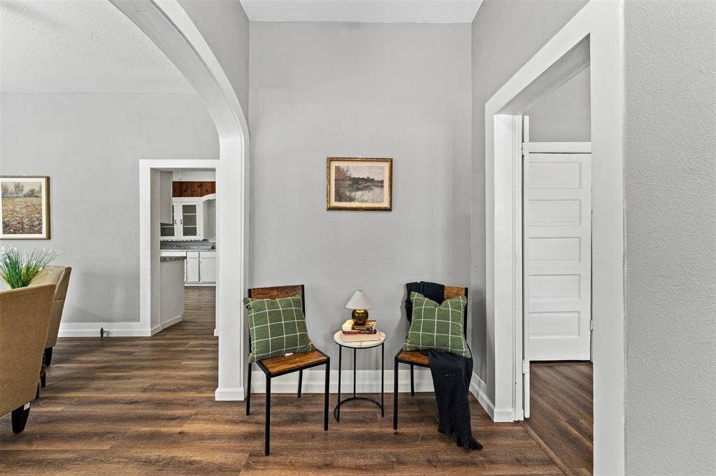 302 W Broadway Street, West, TX 76691 Wood-finish flooring throughout, framed archway, white trim, and a paneled interior door