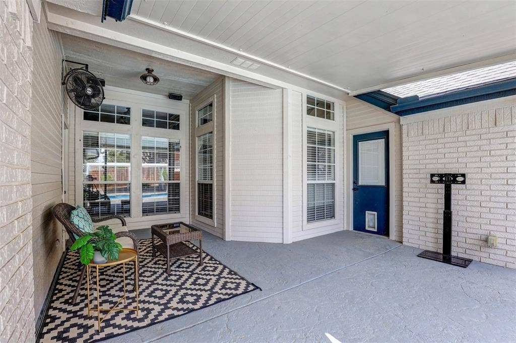 Covered patio featuring a ceiling fan, recessed lighting, and a blue exterior door