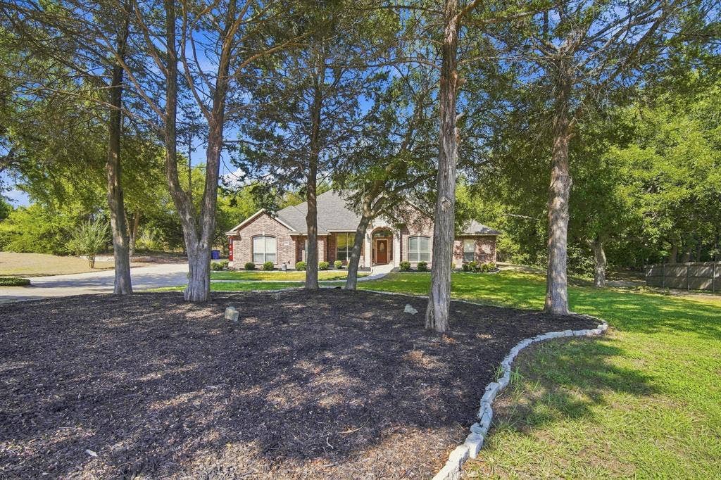 A graceful arched entry adds timeless curb appeal to the brick exterior.