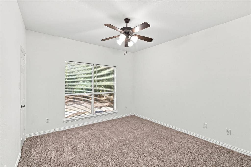 Comfortable bedroom with soft neutral carpeting and crisp white walls, ready for your personal touch.