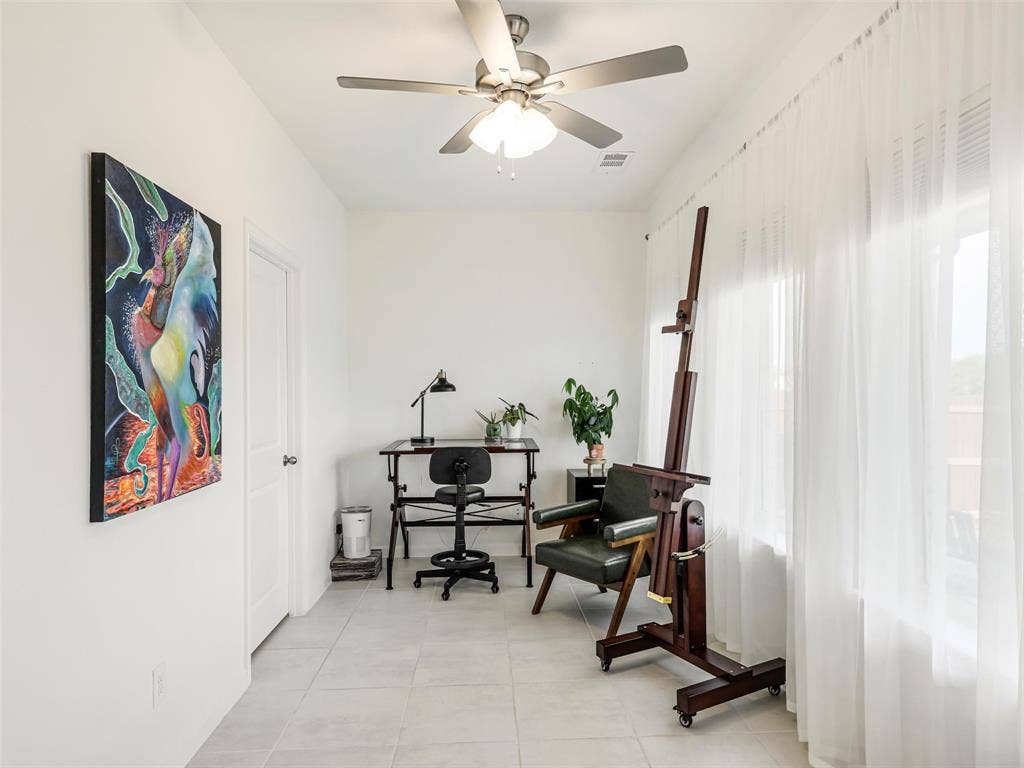 Recessed lighting, ceiling fan, white paneled door, large windows, and tile flooring
