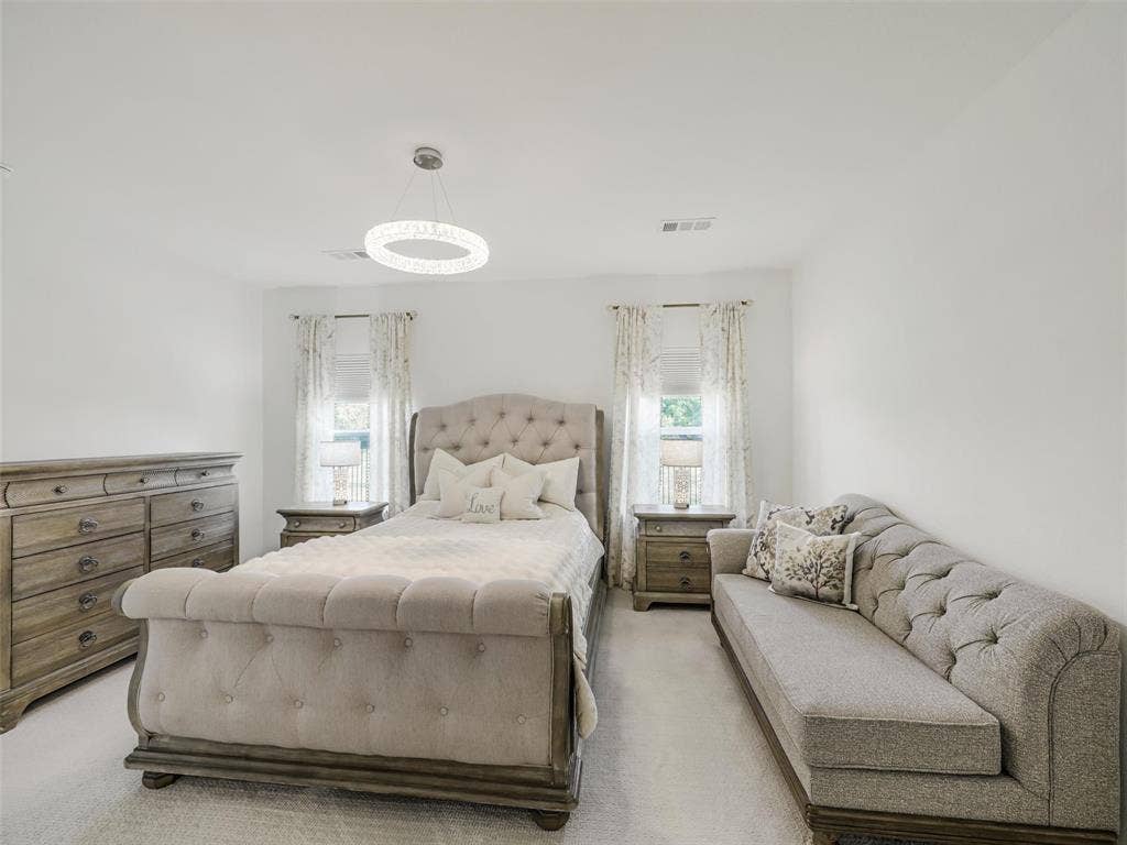 Recessed lighting, light-colored walls, and carpet flooring