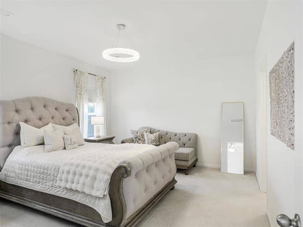Recessed window with wall-to-wall carpeting, and a modern circular chandelier