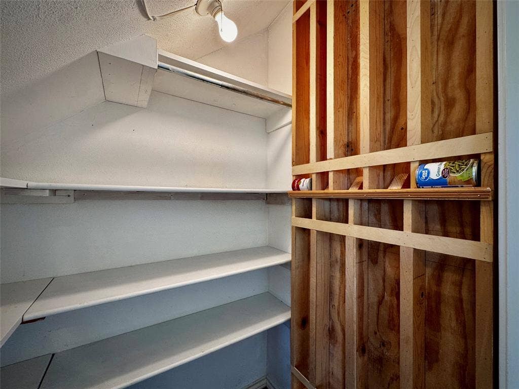 2305 Mccoy Court, Carrollton, TX 75006 Additional pantry space under the stairs... don't miss this fun canned storage wall!