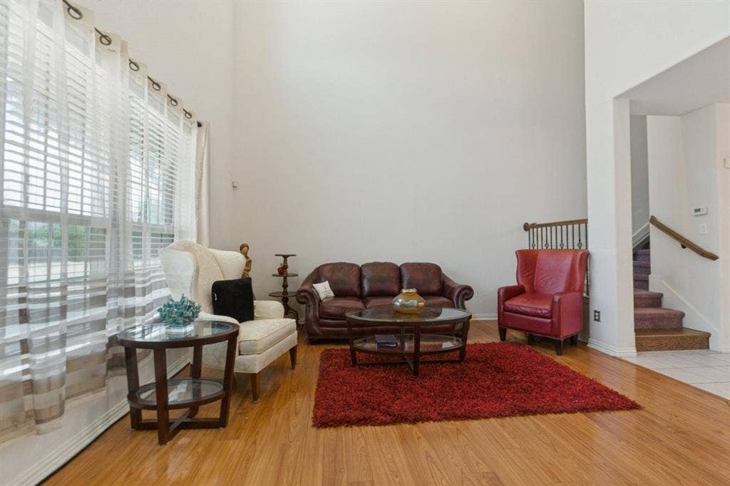 524 S Greenville Avenue, Richardson, TX 75081 High ceilings enhance the spacious living area featuring wood-finish flooring and large windows