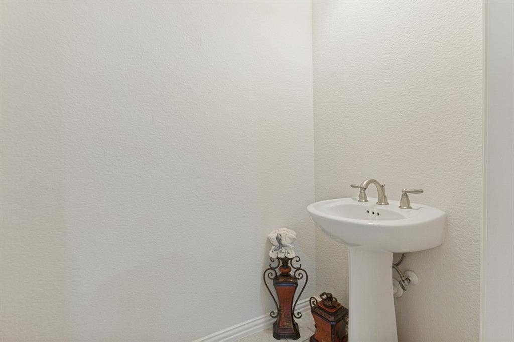 524 S Greenville Avenue, Richardson, TX 75081 Pedestal sink with a brushed nickel faucet set