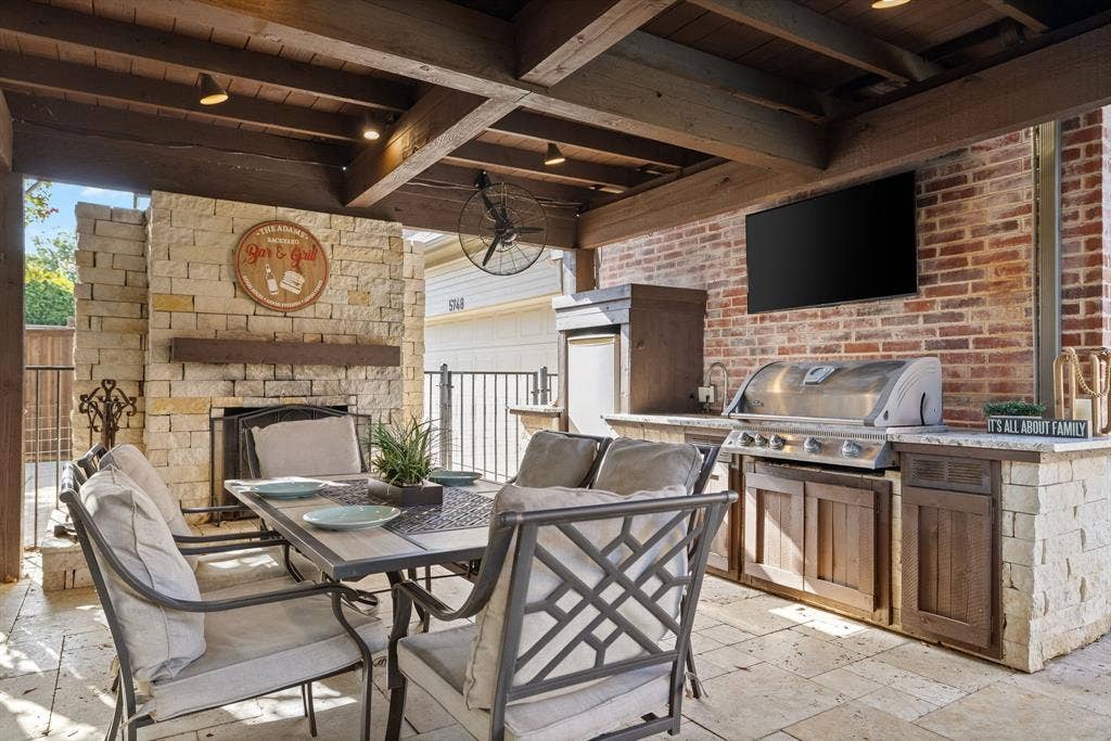 5748 Clarendon Drive, Plano, TX 75093 Outdoor living center with fireplace, grill, sink & fridge.