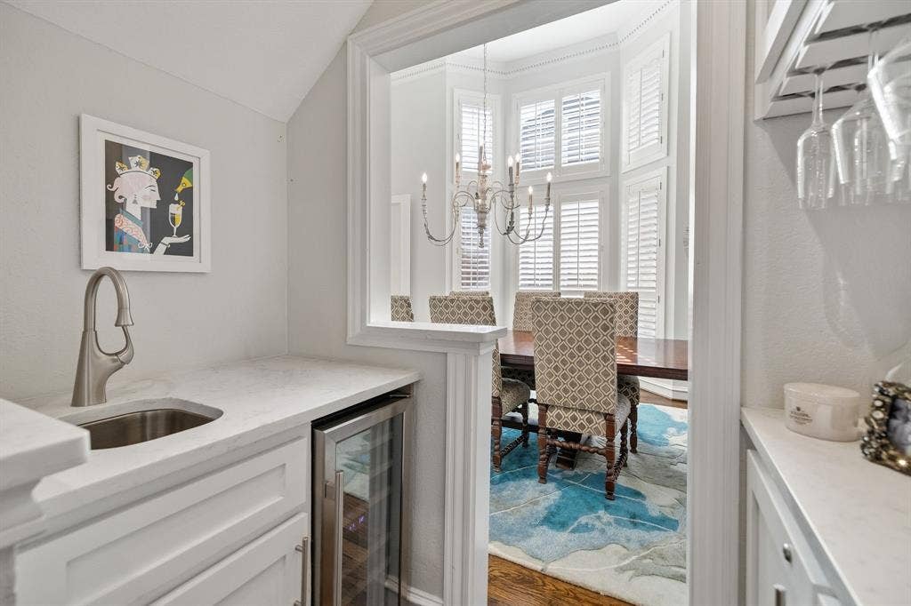 5748 Clarendon Drive, Plano, TX 75093 Renovated wet bar with custom cabinetry, wine storage, wine glass display, sink & wine fridge.