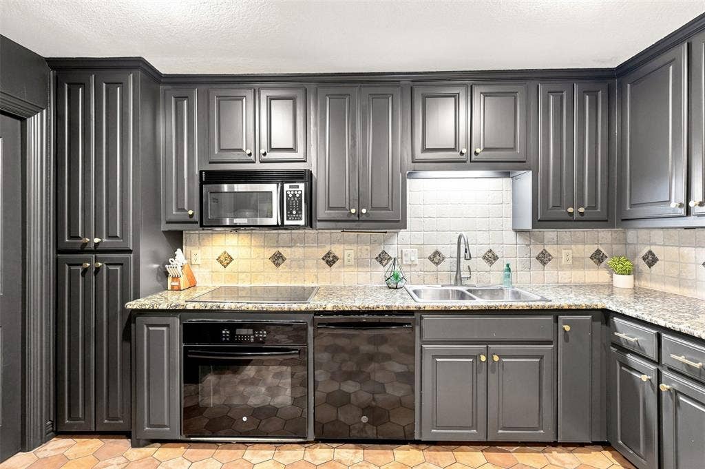 284 Shoreline Drive N, Azle, TX 76020 Kitchen featuring dark cabinetry, speckled countertops, a tile backsplash with diamond accents, and stainless steel appliances