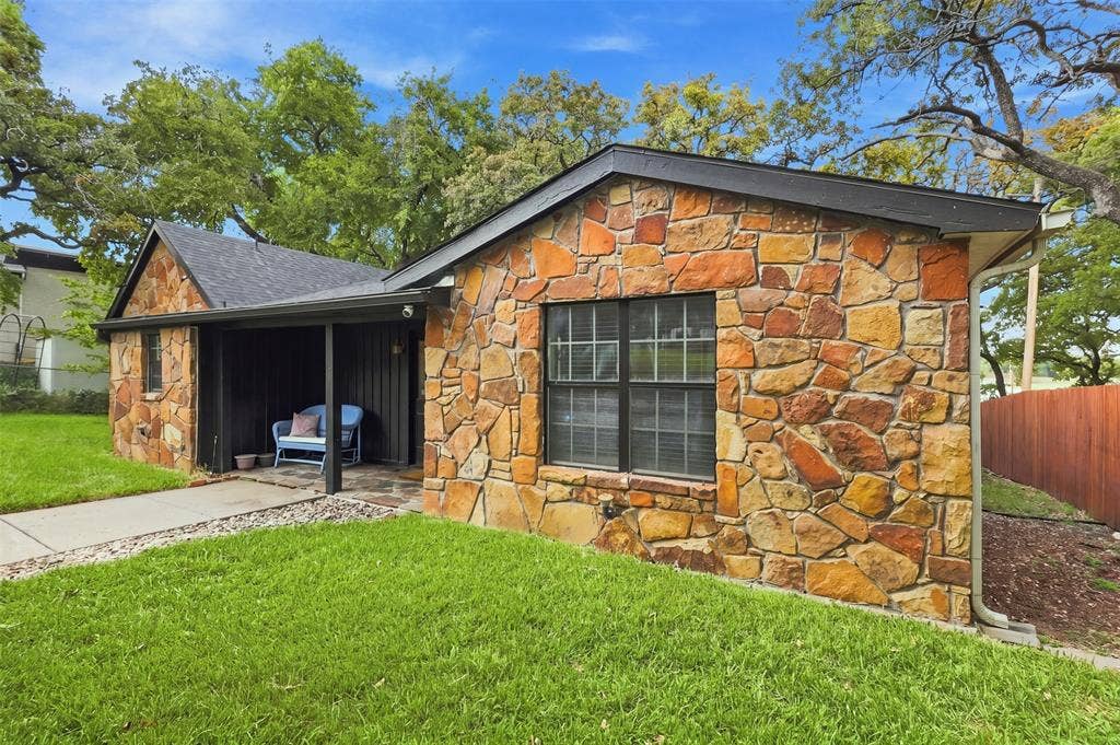 284 Shoreline Drive N, Azle, TX 76020 Stone veneer exterior with a covered porch entry, black trim windows, and a shingle roof
