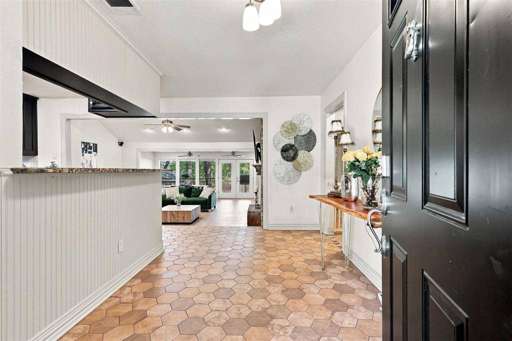 284 Shoreline Drive N, Azle, TX 76020 Hexagonal tile flooring, beadboard paneling, granite-finish countertop, recessed lighting, and ceiling fans